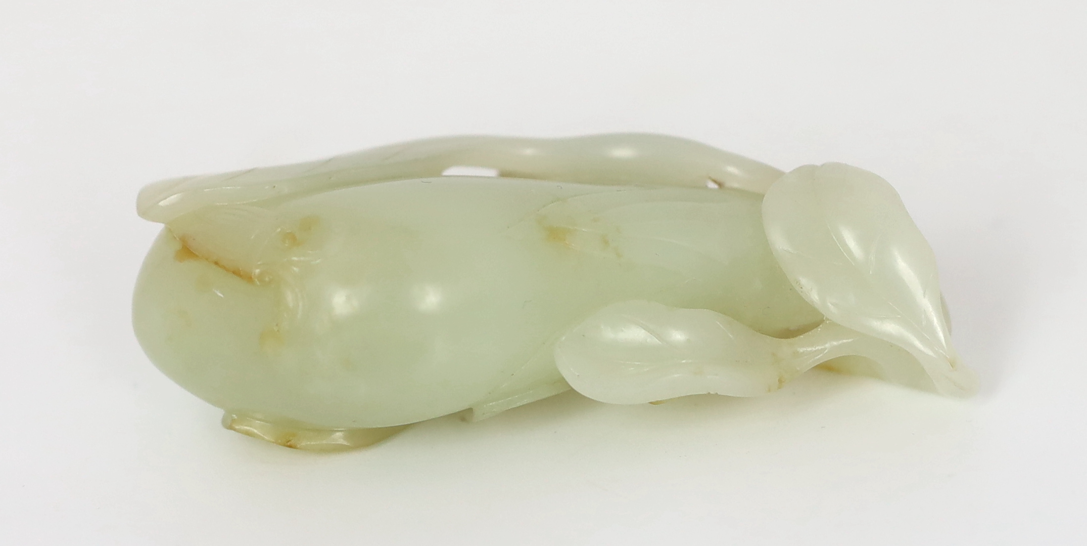 A Chinese pale celadon jade carving of a fruit, 18th century